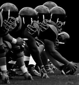 The football team lined up for the upcoming play is an iconic image for football fans all across America.