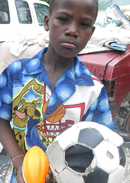 This child's soccer ball was broken, but the volunteers at Schools for Haiti changed that.